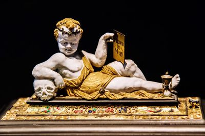 Low angle view of statue against black background