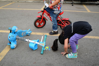 Low section of children playing with bicycle