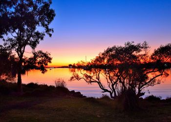 Scenic view of calm lake at sunset