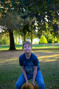 Portrait of boy sitting on land