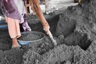 Low section of woman working at construction site. 