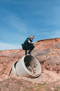 Woman photographing while standing on landscape