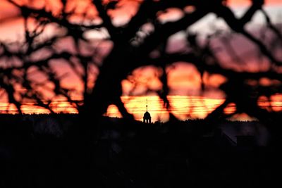 Silhouette of illuminated lights at sunset