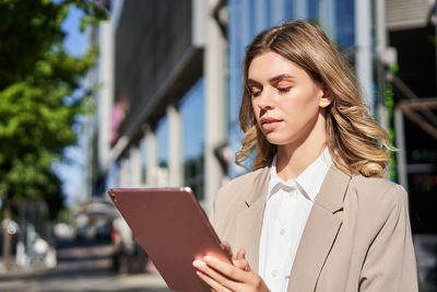 Young businesswoman using digital tablet