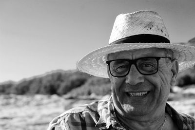 Close-up portrait of senior man against sky