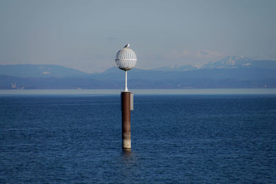 Scenic view of sea against mountain range