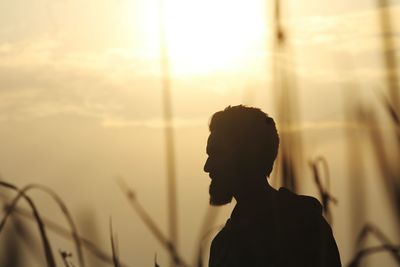 Silhouette man against sky during sunset