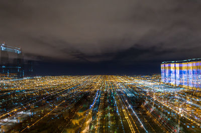 High angle view of illuminated buildings in city at night