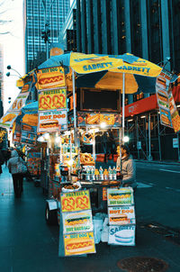 People at market stall in city