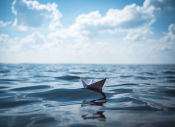 Paper boat floating on sea