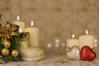 Close-up of christmas decorations with candles on table