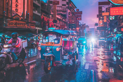 Illuminated city street during rainy season