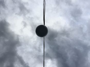 Low angle view of street light against cloudy sky
