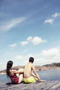 Couple sitting on jetty