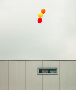 Balloons flying against wall