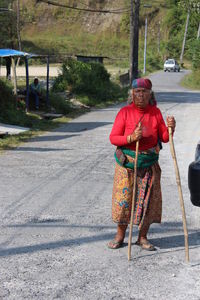 Rear view of a woman walking on road