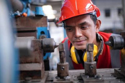 Industrial engineers in hard hats.work at the heavy industry manufacturing factory.