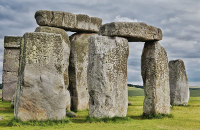 Stone structure on field against sky