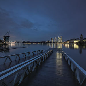 Pier over sea against sky at night