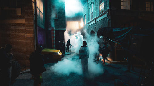 People standing on street at night