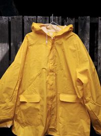 Close-up of clothes hanging on yellow outdoors