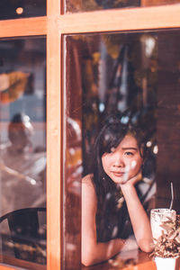 Young woman sitting on table at restaurant