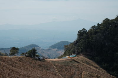 Scenic view of field and mountains against sky