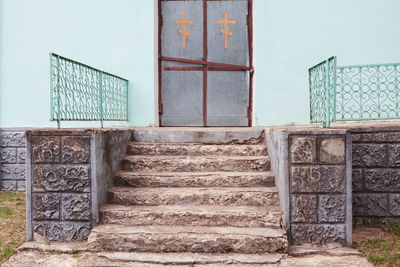 Staircase to church entrance . religious cross on the door