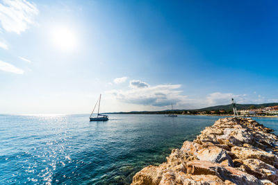 Sailboat in sea against sky