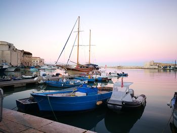 Boats moored at harbor