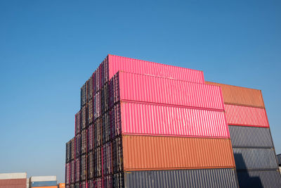 Low angle view of industrial building against clear blue sky