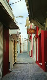 Narrow alley amidst houses in city