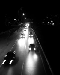 Vehicles on road in city at night