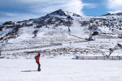 Person skiing on snow against mountain