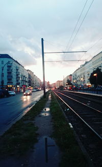 Cars on road in city against sky