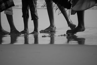 Girls enjoying the beach an the ocean in their own beautiful way.