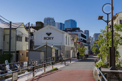 Street amidst buildings against clear sky