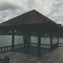 Man standing by built structure against sky