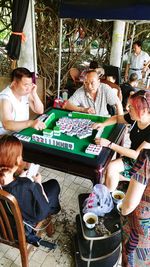 People in traditional clothing sitting on table