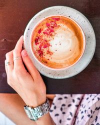 Midsection of woman holding coffee