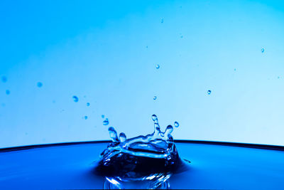 Close-up of water drop on blue surface