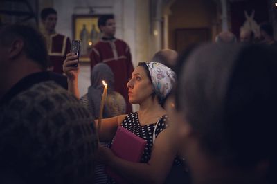 Young woman photographing through smart phone