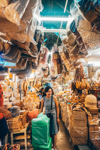 Woman standing at market stall