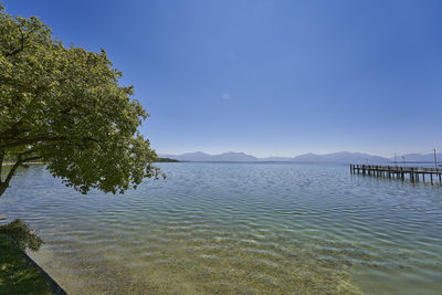 Scenic view of lake against clear blue sky