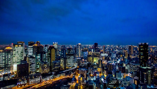 High angle view of illuminated city buildings at night