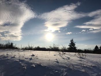 Scenic view of snow covered landscape against sky