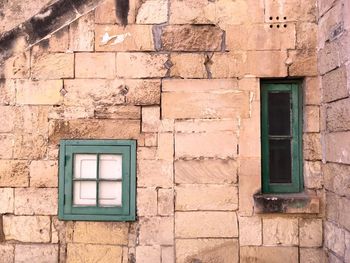 Closed windows on old wall