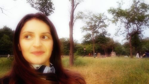 Portrait of smiling young woman in park