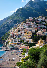 High angle view of townscape by mountain against sky