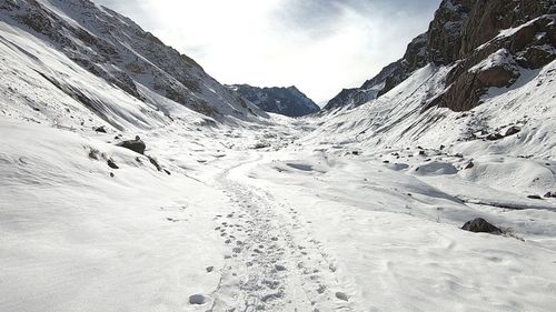 Scenic view of snow covered mountains against sky